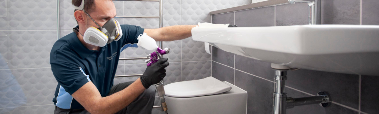 Man repairs bathroom sink and basin