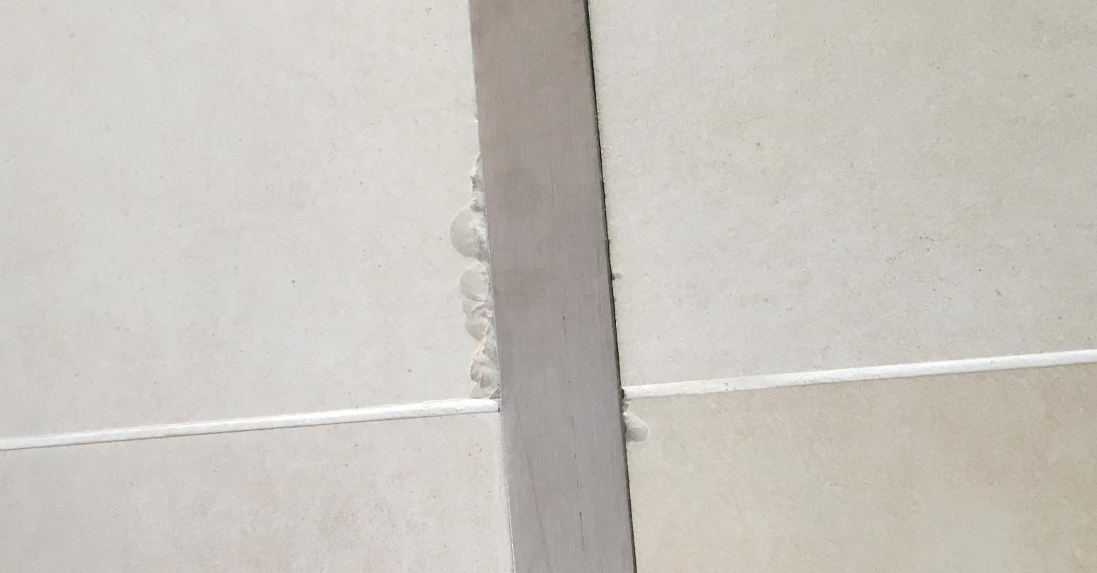 Chipped ceramic floor tile - Before repair