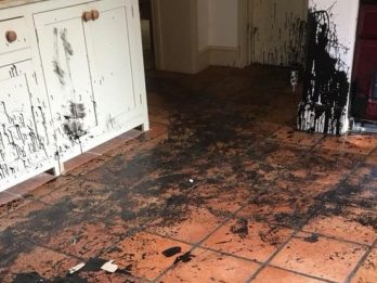 Black gloss paint splatters to kitchen cupboard doors