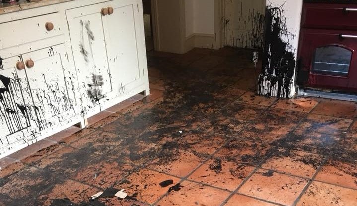 Black gloss paint splatters to kitchen cupboard doors
