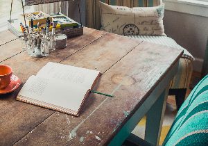 Notebook sat on a wooden table