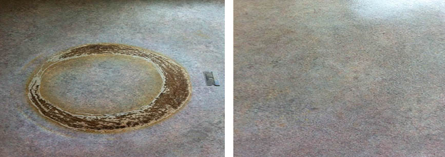 A burnt ring of damage from a pan, on a laminate worktop surface.