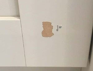 Damaged paint on cupboard door