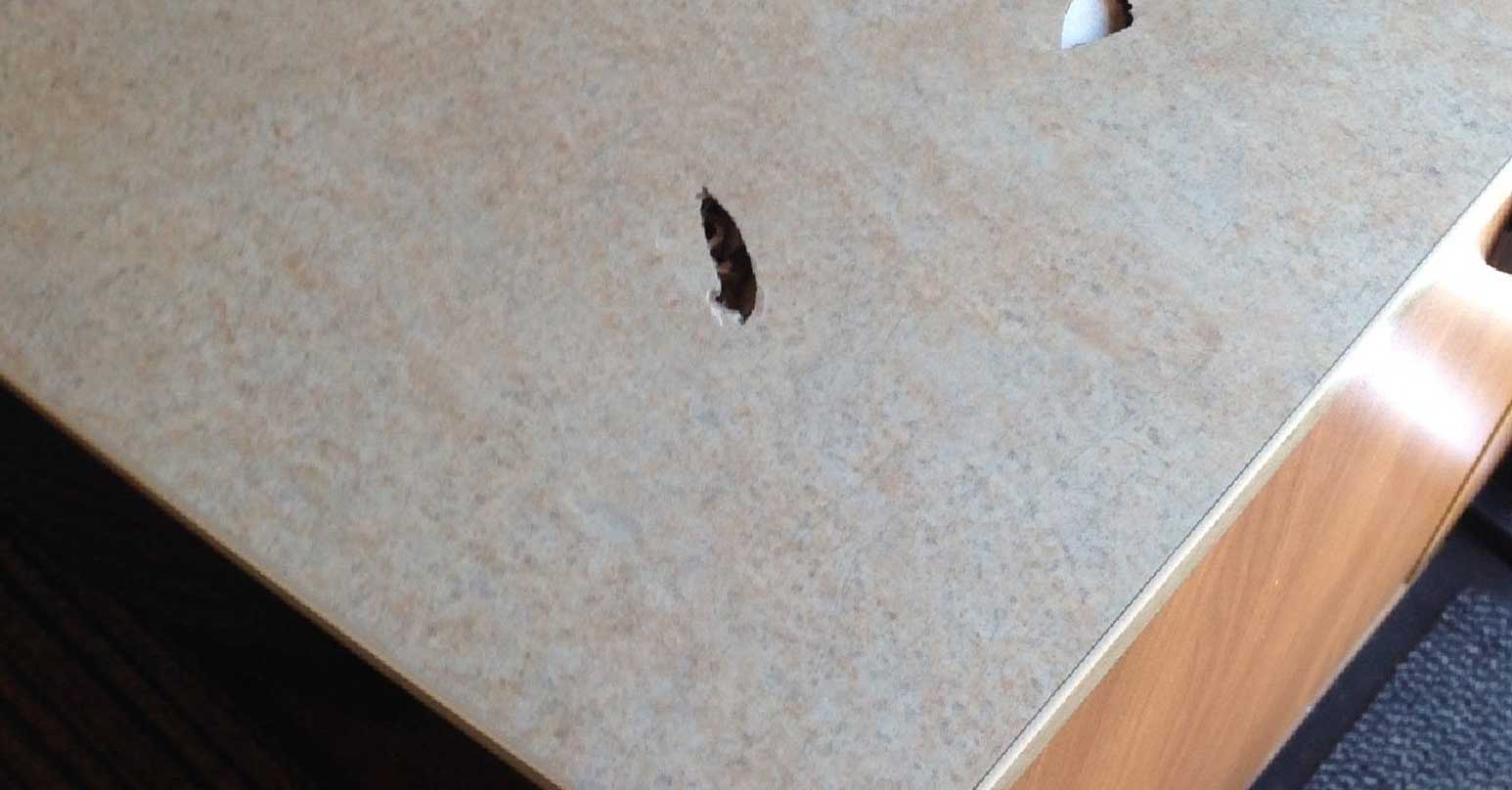 Hole in laminate table - Before repair