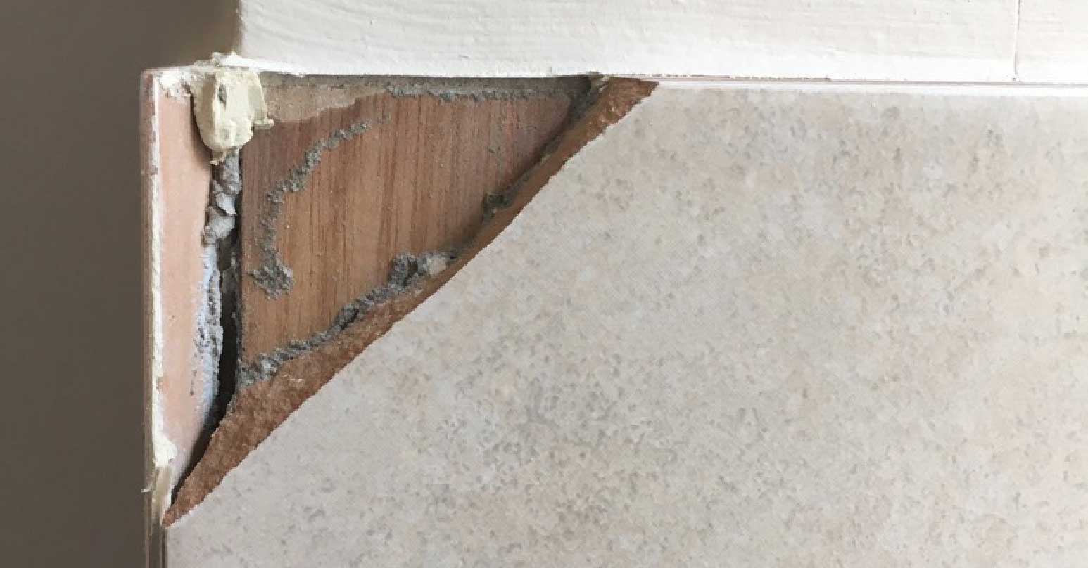 Chip damage to wall tile - Before repair