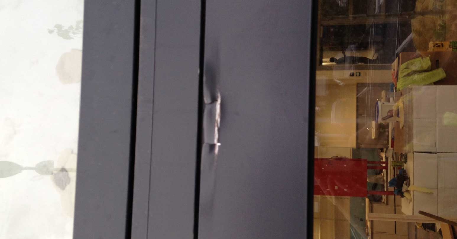 Dented metal window frame