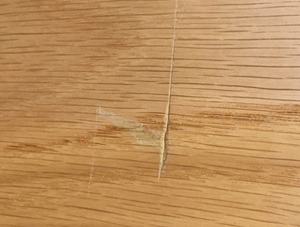 Scratch on wooden cupboard