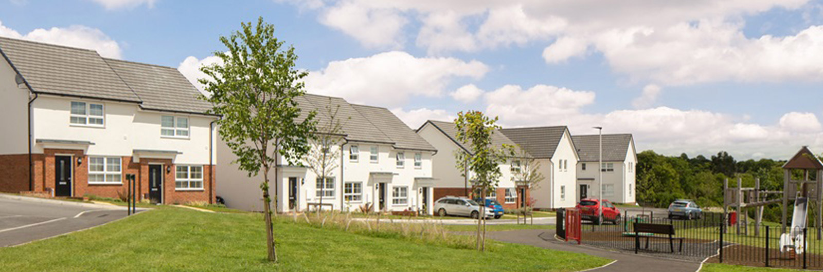 A banner from Barratt Homes, showing a row of new build housing.